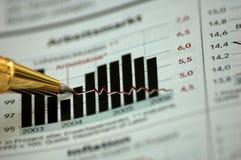 Golden pen showing diagram on financial report