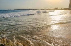 Golden sunlight reflecting on a beach in Lagos, Nigeria. Sun shining in the evening - waves breaking on the shore royalty free stock photo Golden sunlight reflecting on a beach in Lagos, Nigeria. Sun shining in the evening - waves breaking on the shore royalty free stock photo