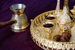 Golden Traditional Arabic coffee set with dallah, coffee pot jezva, cup and dates. Dark background. stock photos Golden Traditional Arabic coffee set with dallah, coffee pot jezva, cup and dates. Dark background. stock photos
