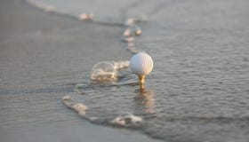 Golf Ball In The Sea Royalty Free Stock Image