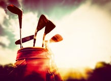 Golf clubs in a leather baggage in vintage, retro style at sunset stock photography Golf clubs in a leather baggage in vintage, retro style at sunset stock photography