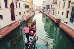 Gondola taking tourists for ride in Venice