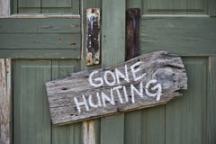 Gone Hunting. Gone hunting sign on old door Gone Hunting. Gone hunting sign on old door