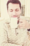 Good looking adult man savouring the aroma of a cup of fresh hot stock photo Good looking adult man savouring the aroma of a cup of fresh hot stock photo