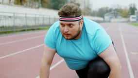 Good Looking Fat Man in the Sports Outfit at Starting Line he Getting Ready  for a Hard Workout in the Stadium Outside Stock Footage - Video of athlete,  diet: 209207104