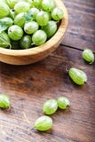 Gooseberry in a wooden plate stock photography Gooseberry in a wooden plate stock photography