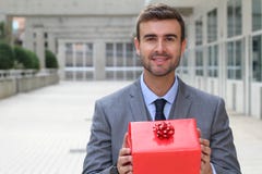 Gorgeous male holding a red present royalty free stock photography Gorgeous male holding a red present royalty free stock photography