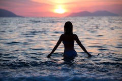 Gorgeous sexy fit woman silhouette swimming in sunset.Free happy woman enjoying sunset. Beautiful woman in water embracing the gol Stock Photo Gorgeous sexy fit woman silhouette swimming in sunset.Free happy woman enjoying sunset. Beautiful woman in water embracing the gol Stock Photo