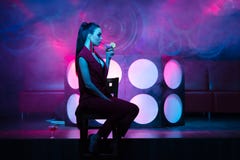 Gorgeous Woman In Nightclub Drinking A Cocktail Sitting On Chair Royalty Free Stock Photography Gorgeous Woman In Nightclub Drinking A Cocktail Sitting On Chair Royalty Free Stock Photography