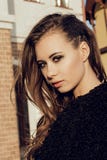 Gorgeous young model woman with perfect brunnete hair looking at camera posing in the city wearing black jacket on stock photography Gorgeous young model woman with perfect brunnete hair looking at camera posing in the city wearing black jacket on stock photography