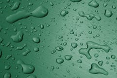 Gotas del agua en superficie de metal Imágenes de archivo libres de regalías Gotas del agua en superficie de metal Imágenes de archivo libres de regalías