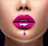 Gotejamento cor-de-rosa do batom Gotejamento de Lipgloss dos bordos 'sexy', gotas líquidas roxas na boca da menina bonita do mode imagens de stock royalty free Gotejamento cor-de-rosa do batom Gotejamento de Lipgloss dos bordos 'sexy', gotas líquidas roxas na boca da menina bonita do mode imagens de stock royalty free