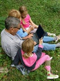 Granddaughter and grandparent with laptop