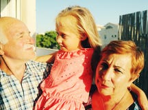 Grandfather and grandmother holding granddaughter royalty free stock image Grandfather and grandmother holding granddaughter royalty free stock image