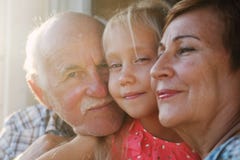 Grandfather and grandmother holding granddaughter stock photos Grandfather and grandmother holding granddaughter stock photos