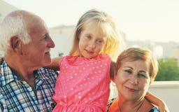Grandfather and grandmother holding granddaughter stock images Grandfather and grandmother holding granddaughter stock images