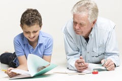 Grandfather helps his grandson with homework royalty free stock image Grandfather helps his grandson with homework royalty free stock image