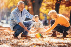 Grandparents and grandson together in autumn park stock photography Grandparents and grandson together in autumn park stock photography