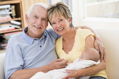 Grandparents in living room with baby royalty free stock image Grandparents in living room with baby royalty free stock image