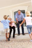 Grandparents Welcoming Grandchildren On Visit stock image Grandparents Welcoming Grandchildren On Visit stock image