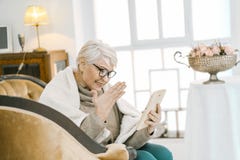 Granny Is Reading Something Pleasant On Her Tablet Royalty Free Stock Photo
