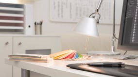 Graphic designers workplace with color guides and a digital pen tablet stock image Graphic designers workplace with color guides and a digital pen tablet stock image