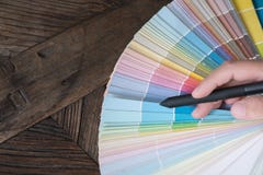 Graphic or interior designer choosing a colour from color swatch royalty free stock photography Graphic or interior designer choosing a colour from color swatch royalty free stock photography