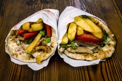 Greek pita gyros souvlaki on a wooden rustic table royalty free stock photography Greek pita gyros souvlaki on a wooden rustic table royalty free stock photography