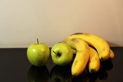 Green apples and bananas black background reflection stock image Green apples and bananas black background reflection stock image