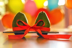 Green avocado with red silk ribbon on colorful balloons background. Healthy care and relationship symbol. Minimal style romance stock images Green avocado with red silk ribbon on colorful balloons background. Healthy care and relationship symbol. Minimal style romance stock images