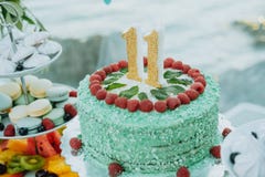 Green cake with number 11 on the table stock photos Green cake with number 11 on the table stock photos