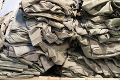 Green camouflage surplus of military clothes in the store for sale stock photos Green camouflage surplus of military clothes in the store for sale stock photos