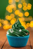 Green christmas cupcake with bokeh on background royalty free stock photography Green christmas cupcake with bokeh on background royalty free stock photography