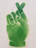 Green crossed fingers stock image Green crossed fingers stock image