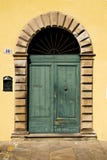 Green Door With Arch In A Yellow Wall, Italy Stock Photography