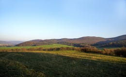 Green field and sky. Mountain at the back. royalty free stock images Green field and sky. Mountain at the back. royalty free stock images