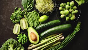 Green healthy food composition with avocado, broccoli, apple, smoothie...
