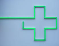 Green led cross on a pharmacy wall