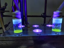 Green Organic photochemical rection in glass vials under metal block cooling condition under blue light for green chemistry royalty free stock image Green Organic photochemical rection in glass vials under metal block cooling condition under blue light for green chemistry royalty free stock image