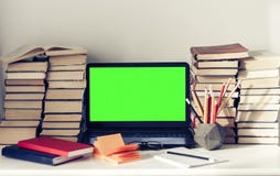 Green screen laptop, stack of books, notebooks and pencils on white table, education office concept background stock image Green screen laptop, stack of books, notebooks and pencils on white table, education office concept background stock image