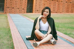 Green shirt woman sitting on the lawn stock images Green shirt woman sitting on the lawn stock images