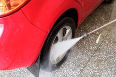 high pressure water jet directed at the wheel of a red car. Car wash image royalty free stock photos high pressure water jet directed at the wheel of a red car. Car wash image royalty free stock photos