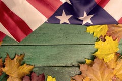 Green vintage wooden background covered with american flag and autumn leaves, copy space stock photos Green vintage wooden background covered with american flag and autumn leaves, copy space stock photos