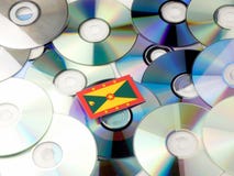 Grenada flaga na górze cd i DVD stosu odizolowywającego na bielu obrazy stock Grenada flaga na górze cd i DVD stosu odizolowywającego na bielu obrazy stock