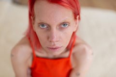 Skinny grey-eyed woman with red hair suffering from anorexia stock images Skinny grey-eyed woman with red hair suffering from anorexia stock images