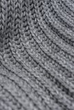 Grey woolen knitted scarf. Closeup view texture with bokeh. stock photography Grey woolen knitted scarf. Closeup view texture with bokeh. stock photography