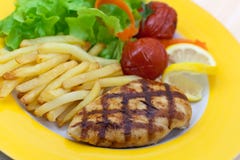 Grilled Chicken Breast With French Fries ,baked To Stock Photography