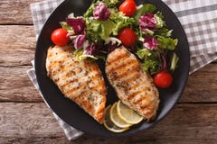 Grilled Chicken Breast With Salad Of Chicory, Tomatoes And Lettuce Close-up. Horizontal Top View Royalty Free Stock Photos