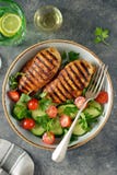Grilled Healthy Chicken Breast With A Salad Of Cherry Tomatoes, Cucumbers, Arugula And Parsley. Top View. Copy Space. Stock Image