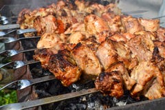Grilled Kebab Cooking On Metal Skewer Closeup. Roasted Meat Cooked At Barbecue. Traditional Eastern Dish, Shish Kebab. Grill On Ch Stock Image Grilled Kebab Cooking On Metal Skewer Closeup. Roasted Meat Cooked At Barbecue. Traditional Eastern Dish, Shish Kebab. Grill On Ch Stock Image